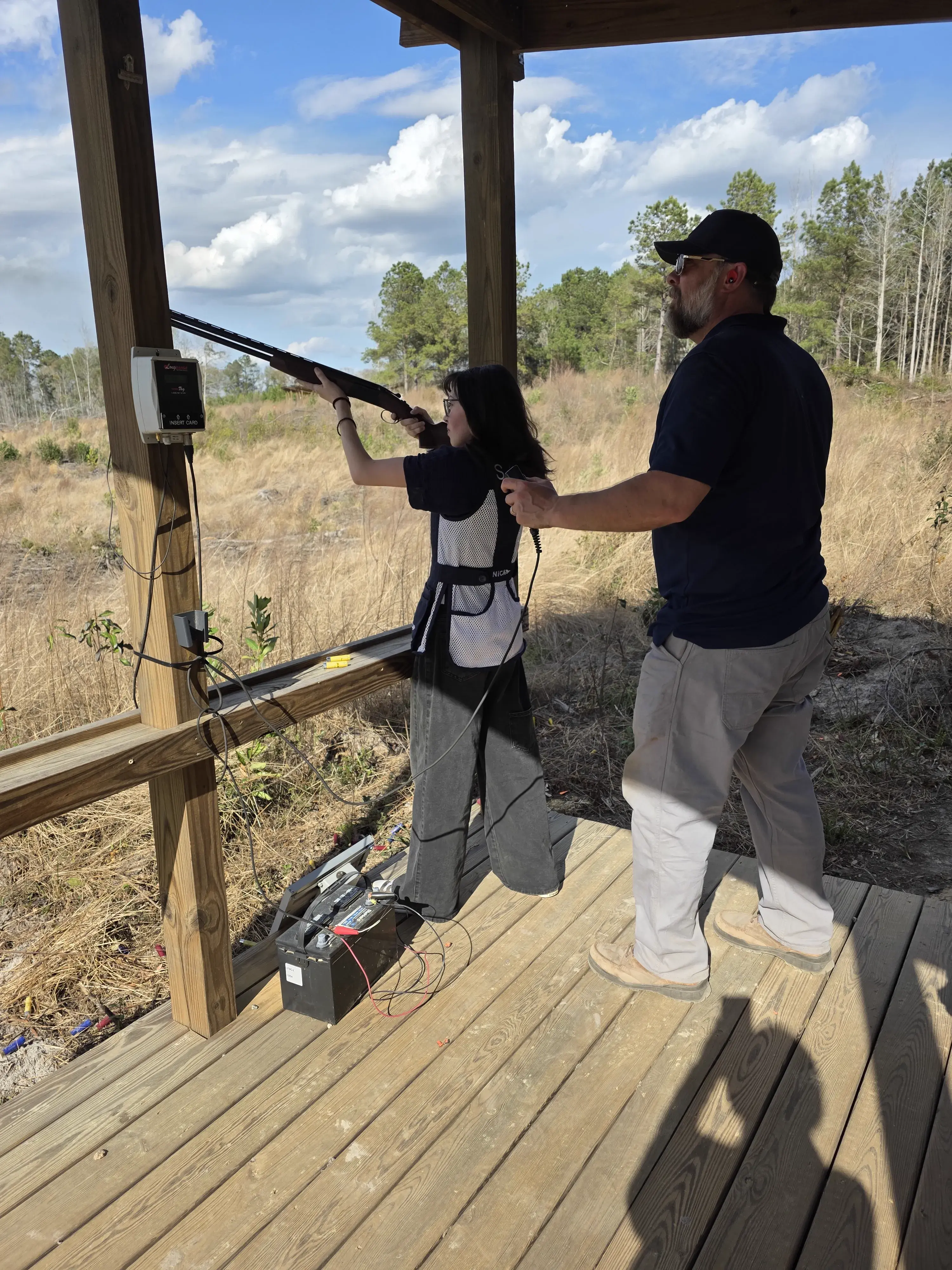 Coach instructing a shooter at Traditions Field Club