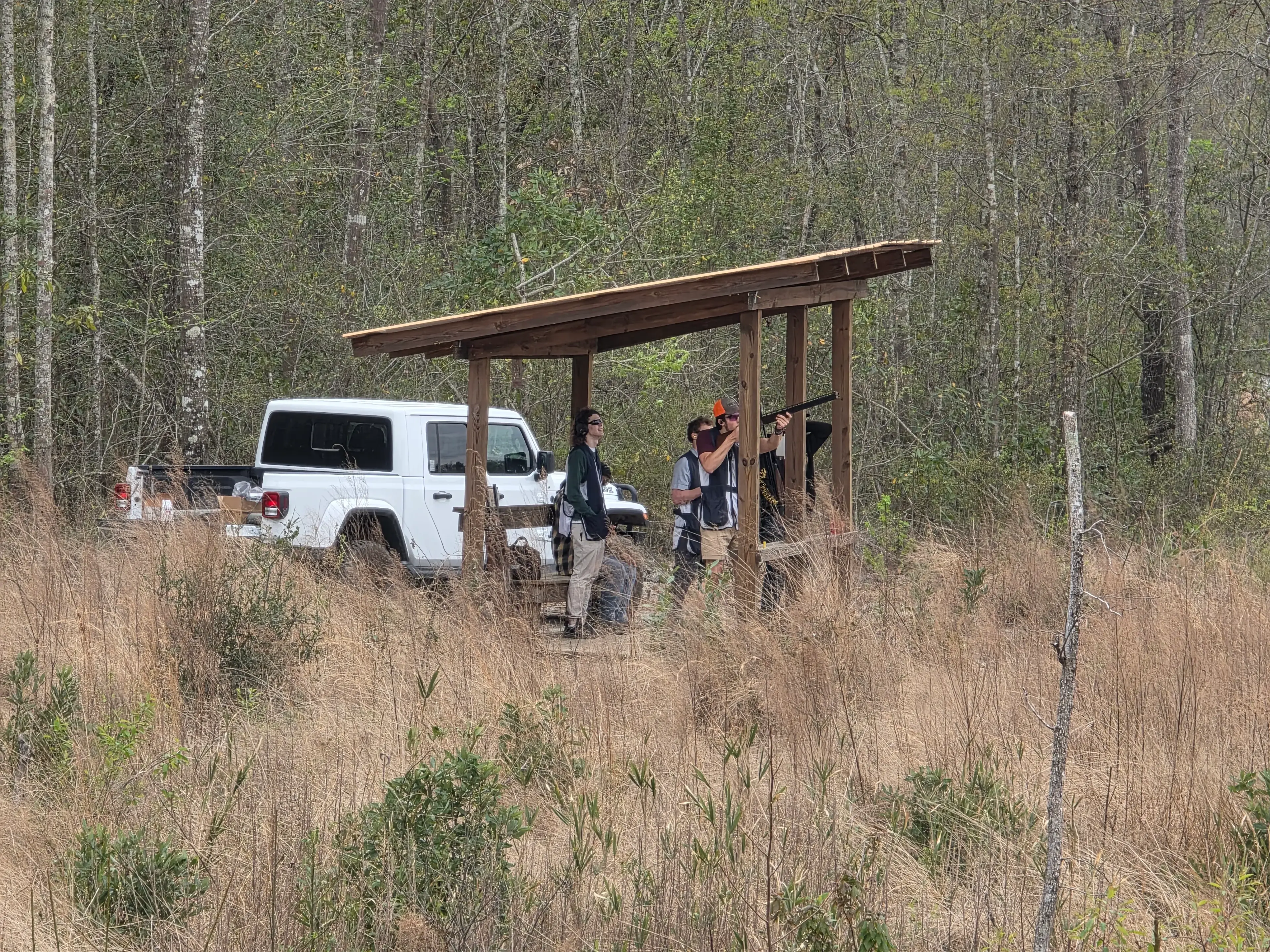 Group at a shooting station with truck