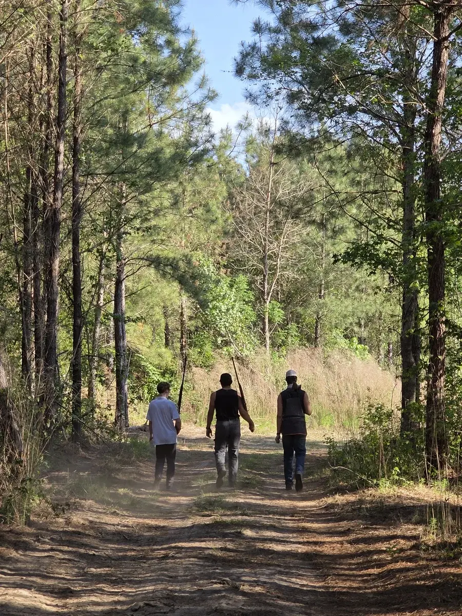 Members hiking a wooded trail at Traditions Field Club