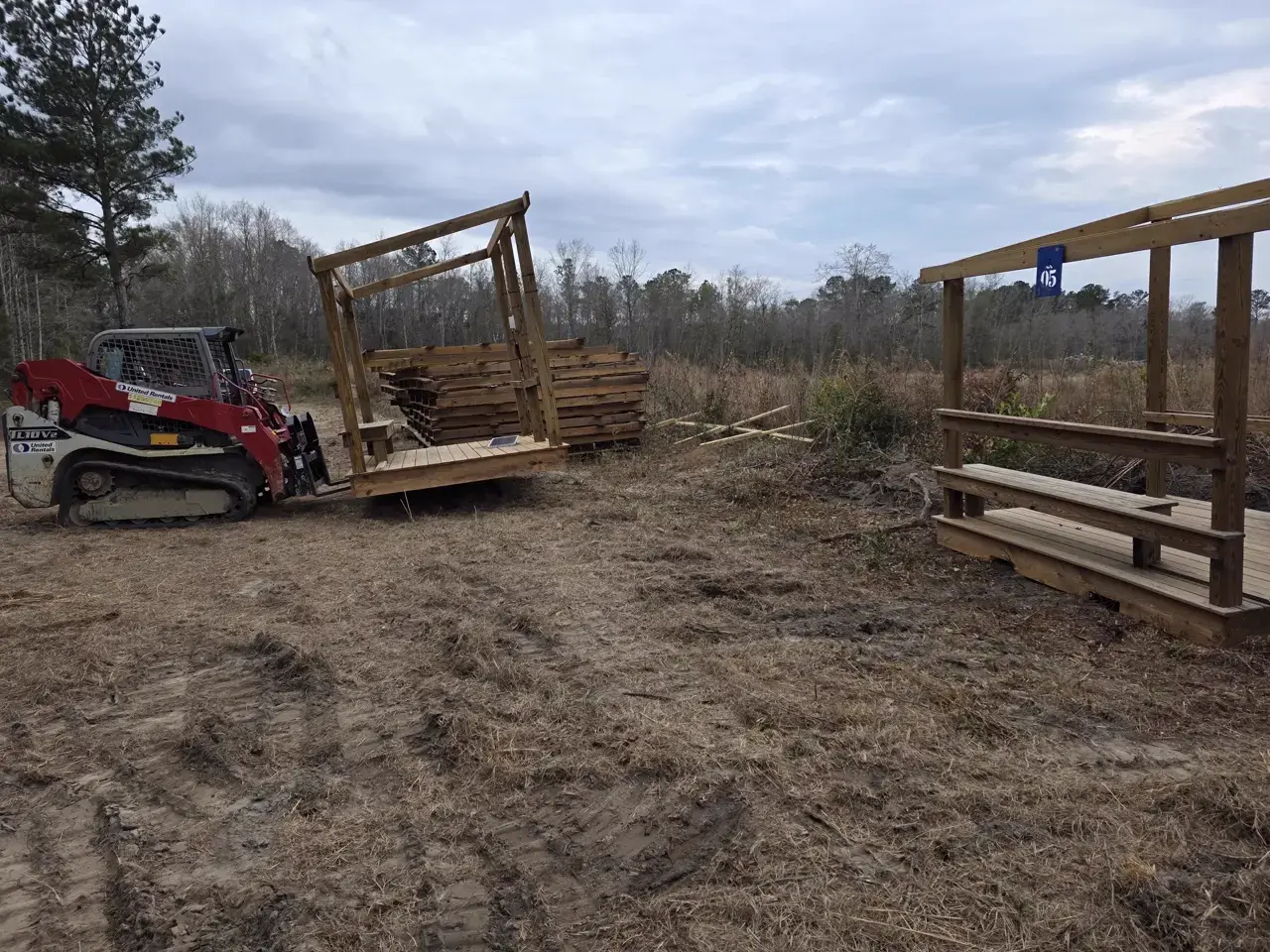 Skid steer delivering lumber to stations