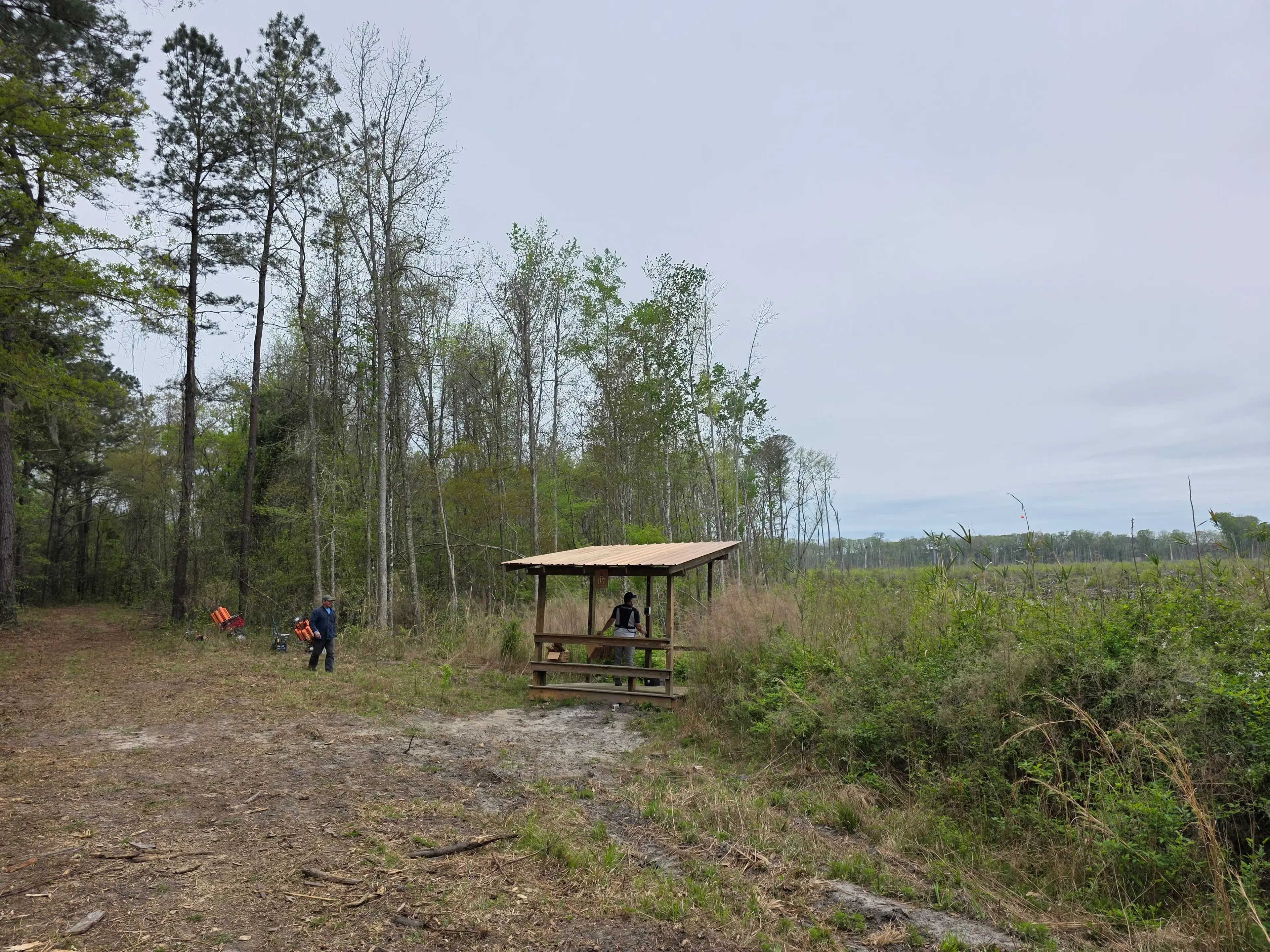 Covered station with crew in the distance