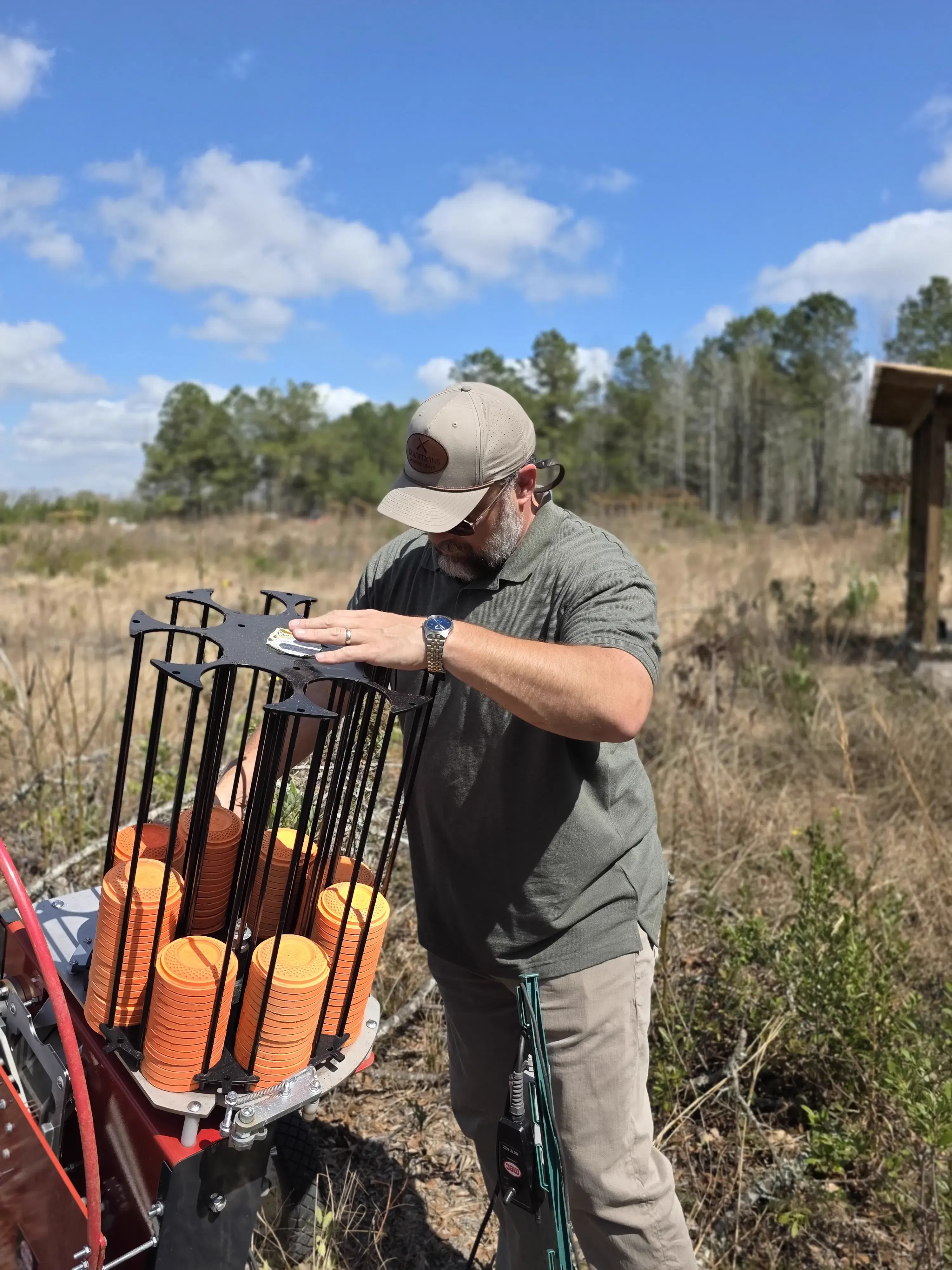 Loading clay targets into a trap machine up close