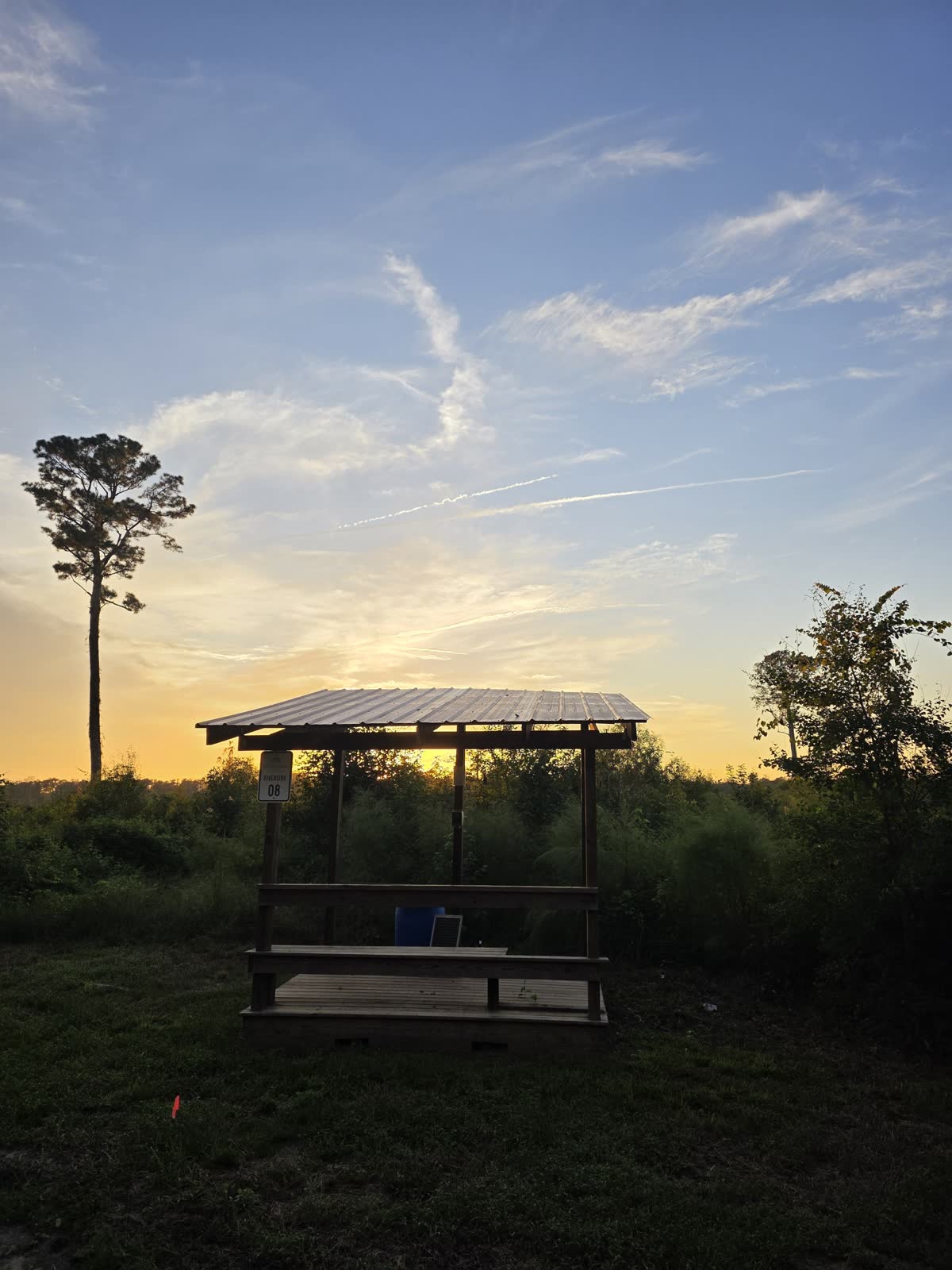 A covered stand at Traditions Field Club at sunset
